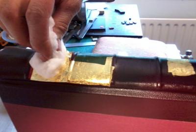 Gold leaf is carefully pressed on using cotton wool
